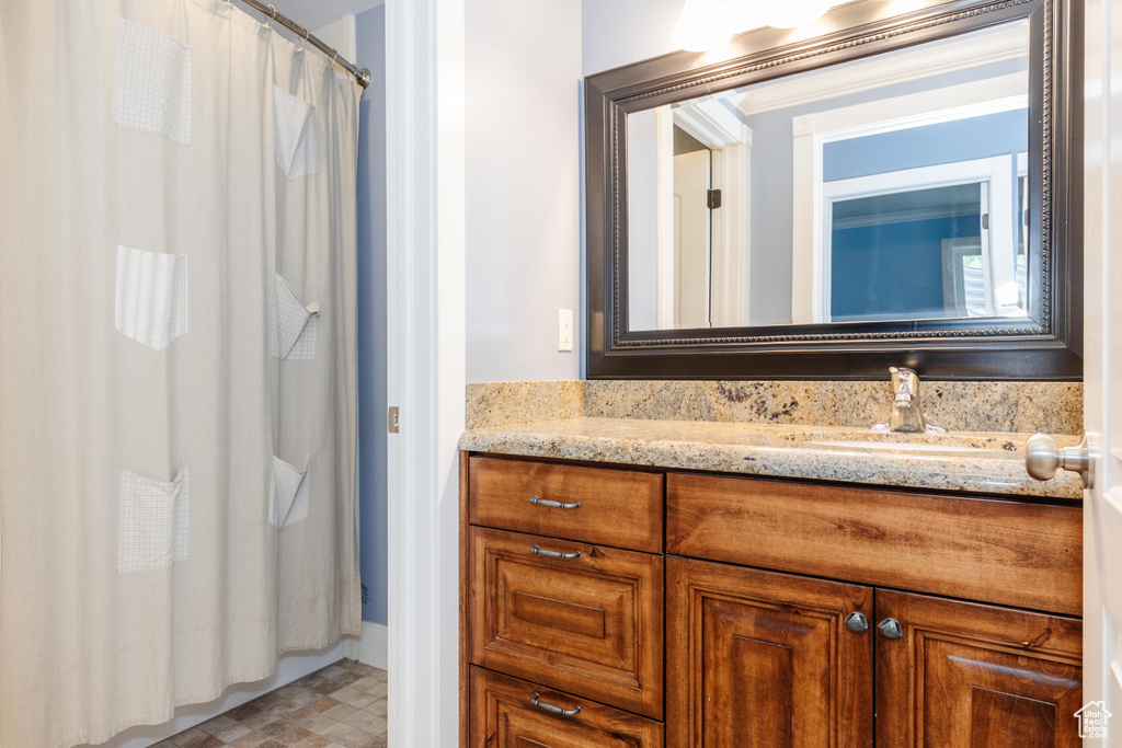 Bathroom with tile patterned flooring and vanity