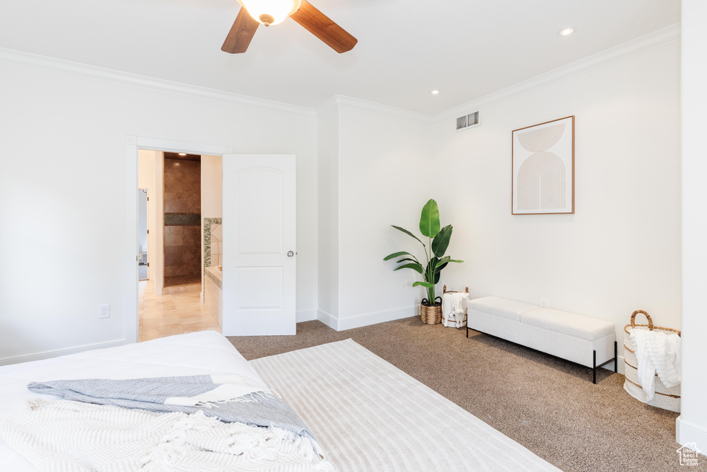 Bedroom with ceiling fan, carpet, and crown molding