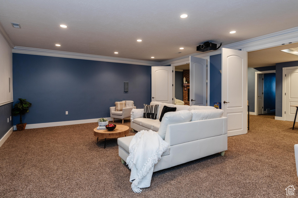 Carpeted living room with ornamental molding