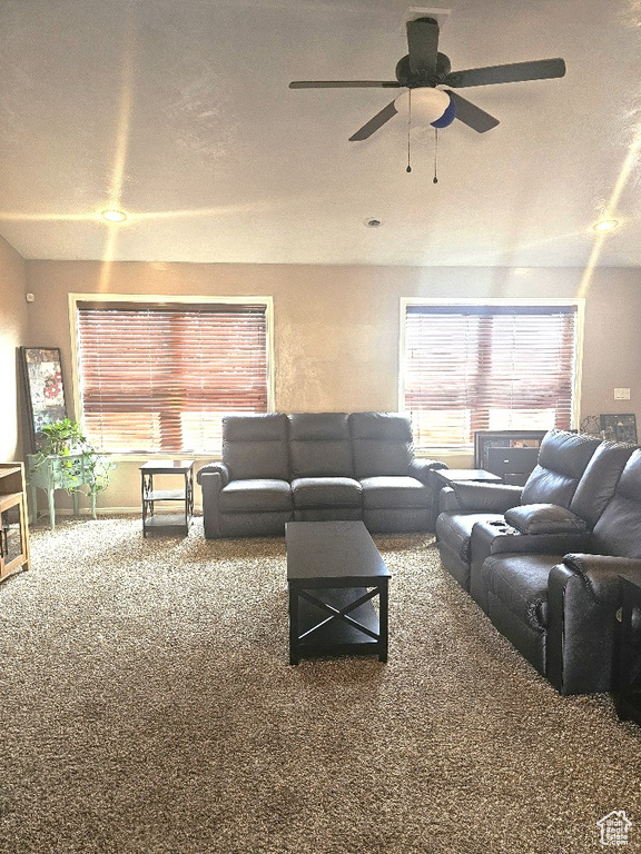 Living room with ceiling fan and carpet