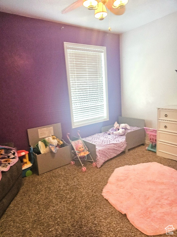 Bedroom featuring ceiling fan and carpet flooring