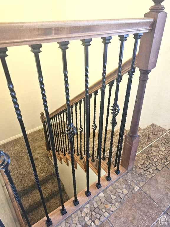 Stairway featuring tile patterned floors