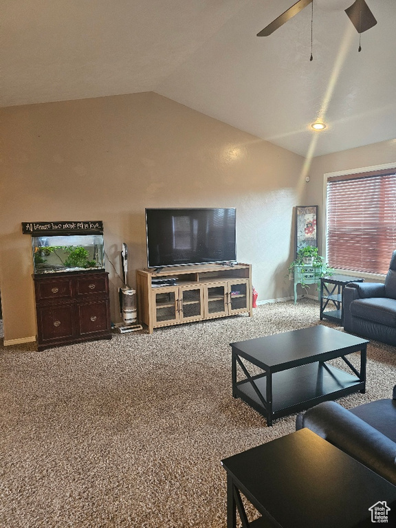 Living room with ceiling fan, vaulted ceiling, and carpet floors