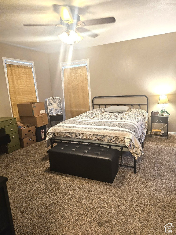 Bedroom featuring ceiling fan and carpet floors