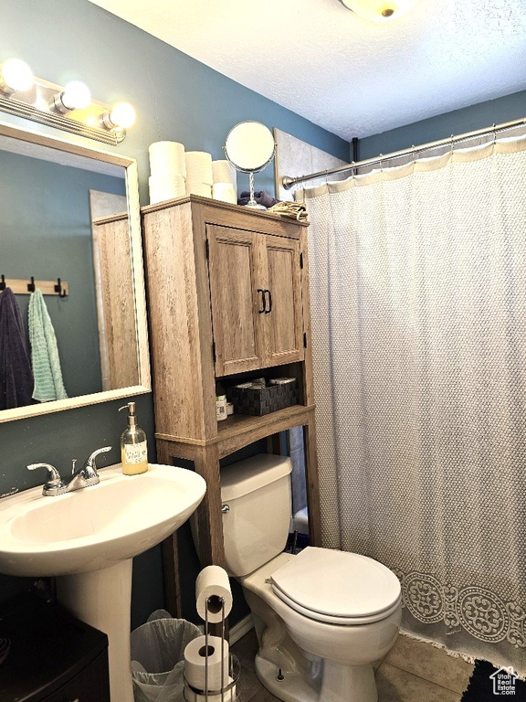 Bathroom with tile patterned floors and toilet