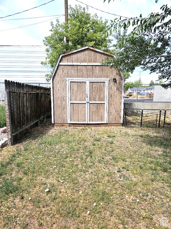 View of outdoor structure featuring a yard