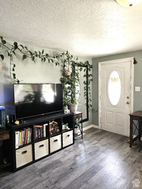 Foyer entrance featuring wood-type flooring and a textured ceiling