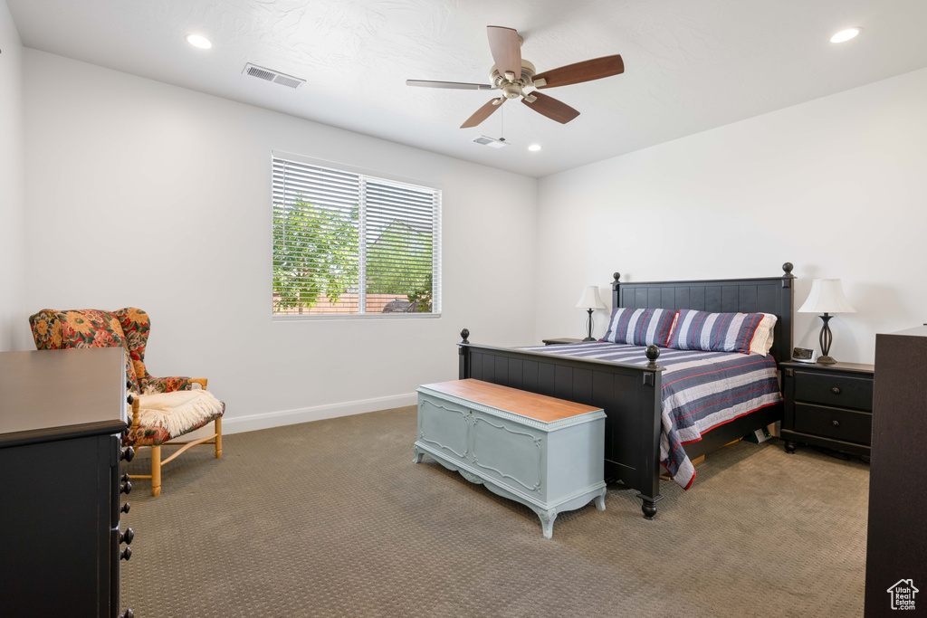 Carpeted bedroom with ceiling fan