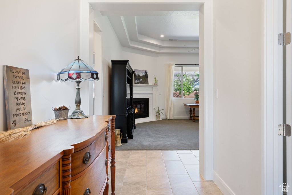 Interior space with light carpet and a tray ceiling