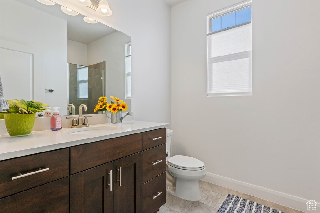 Bathroom featuring tile patterned floors, vanity, and toilet