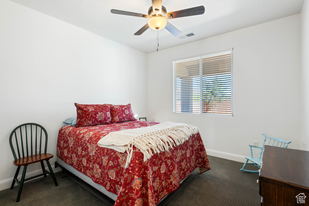 Bedroom featuring ceiling fan and carpet floors