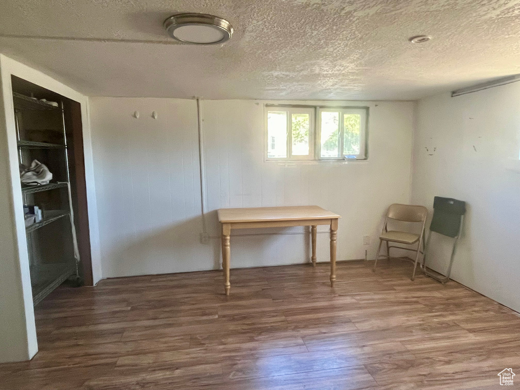 Interior space with a textured ceiling and hardwood / wood-style flooring