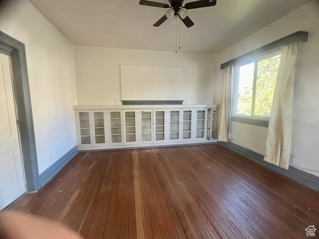 Empty room featuring wood-type flooring and ceiling fan