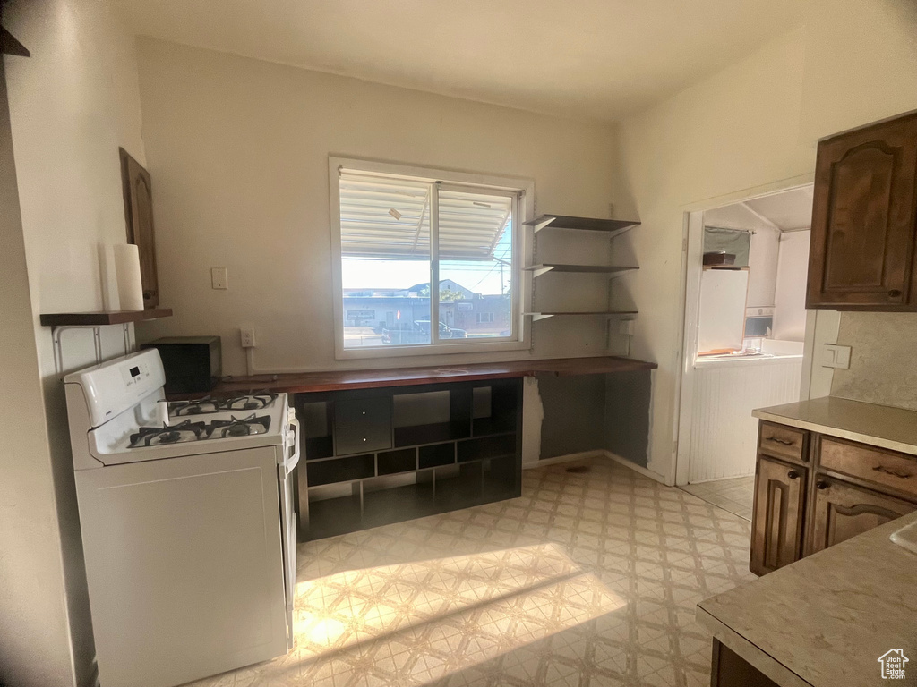 Kitchen featuring white gas range