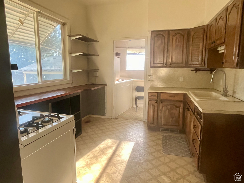 Kitchen featuring gas range gas stove, backsplash, and sink