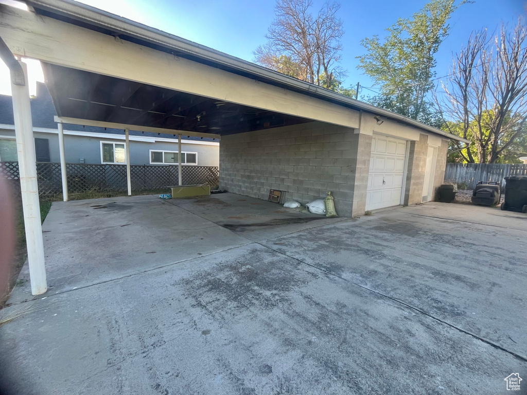 Exterior space featuring a garage and a carport