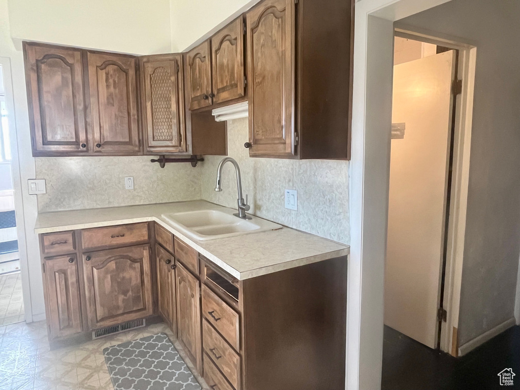 Kitchen featuring backsplash and sink