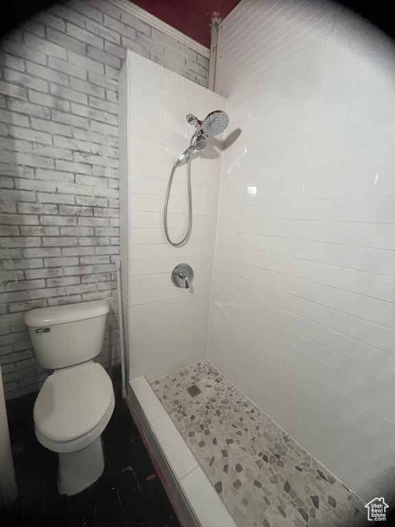 Bathroom featuring toilet and a tile shower