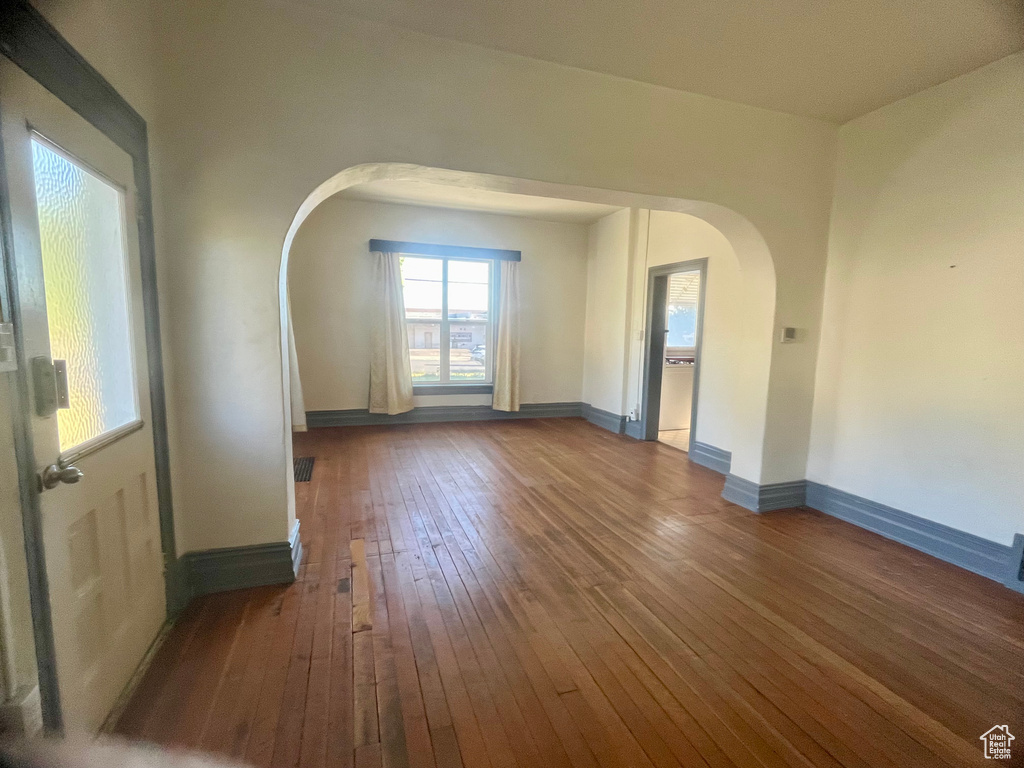 Empty room with dark hardwood / wood-style floors