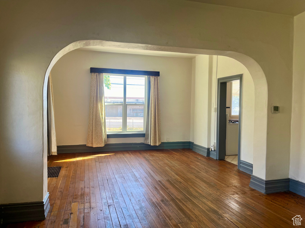 Empty room featuring dark hardwood / wood-style floors