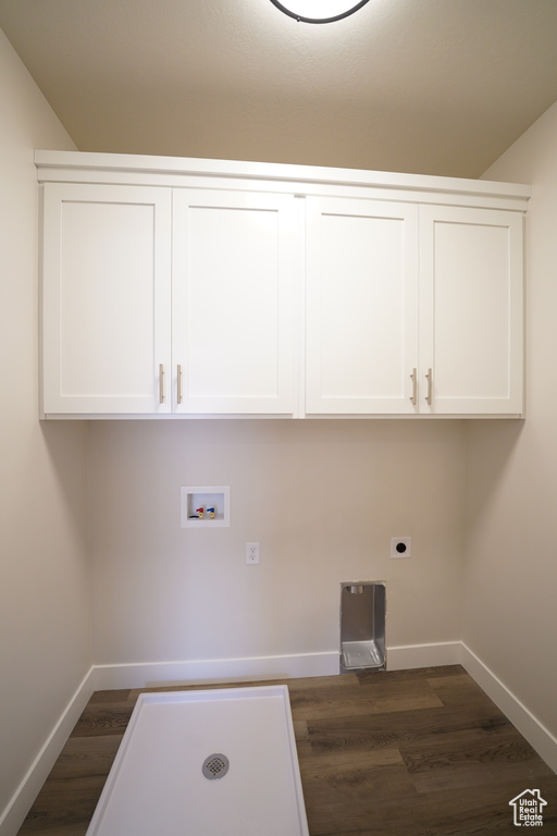 Laundry room featuring electric dryer hookup, dark hardwood / wood-style flooring, cabinets, and hookup for a washing machine