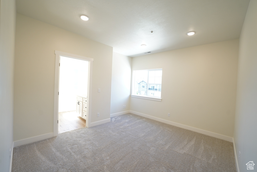 Unfurnished room with light colored carpet