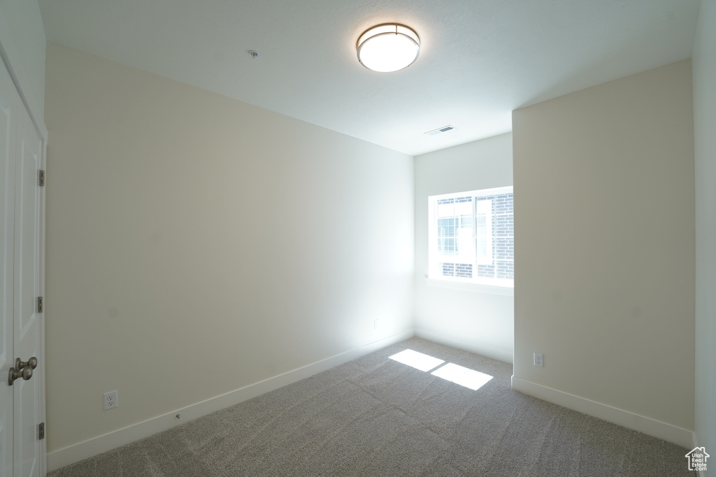 Unfurnished room with carpet