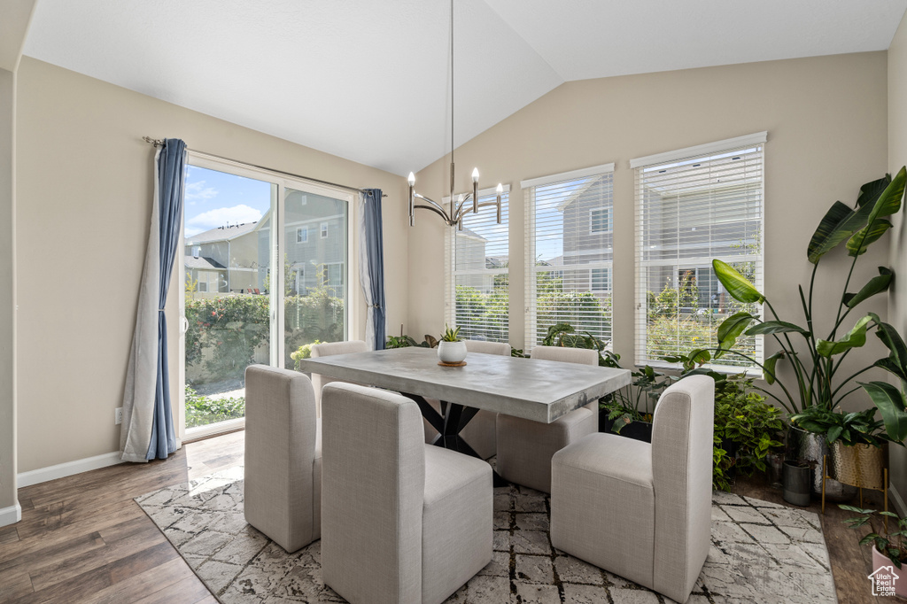 Dining room featuring light hardwood / wood-style flooring, vaulted ceiling, and a healthy amount of sunlight