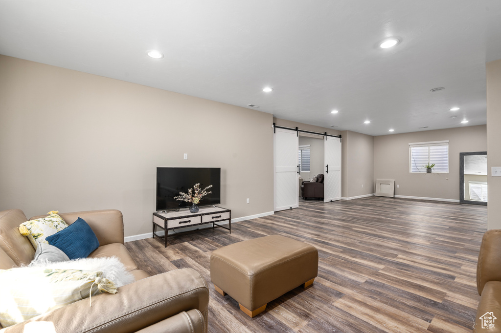 Living room featuring hardwood / wood-style flooring and a barn door