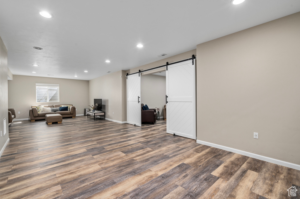 Living room with hardwood / wood-style flooring and a barn door