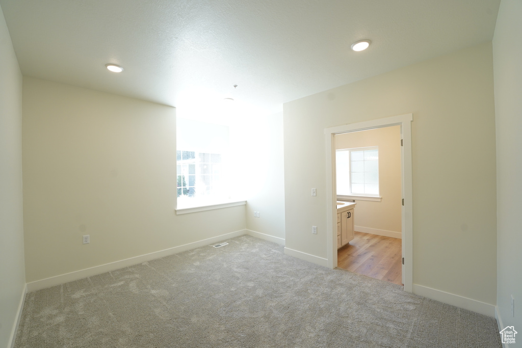 Unfurnished room with light carpet