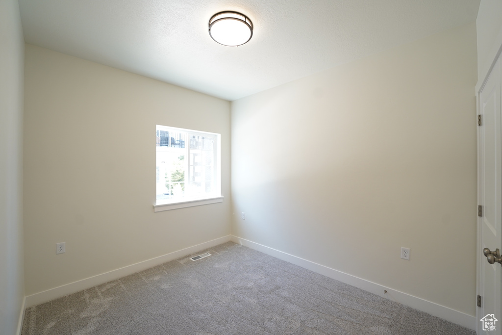 Unfurnished room with carpet flooring