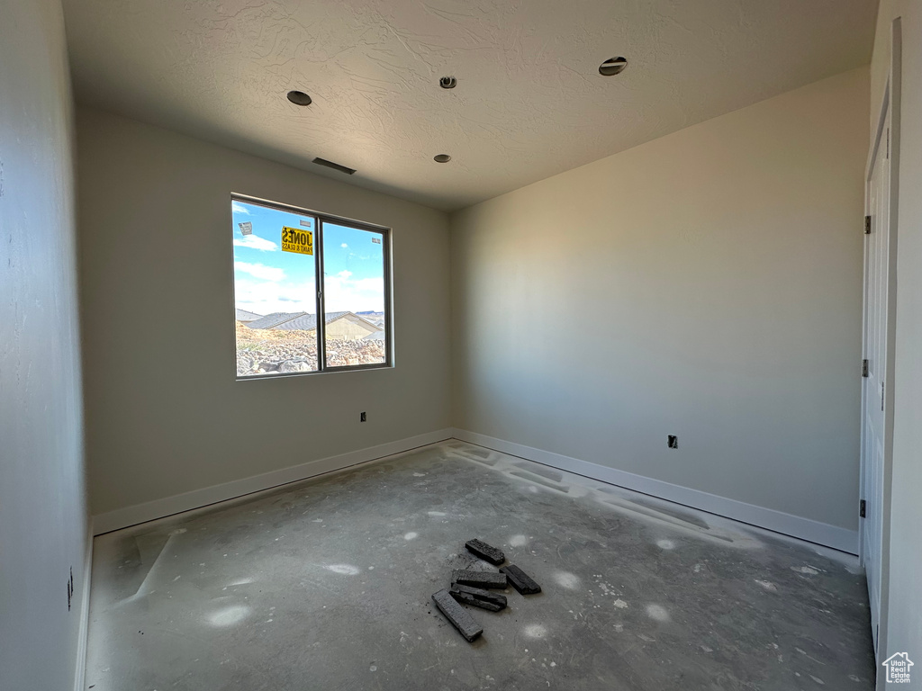 Empty room with a textured ceiling