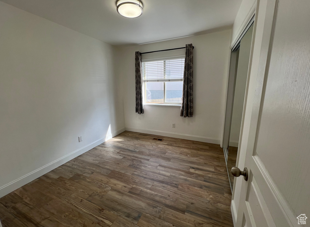 Unfurnished bedroom with hardwood / wood-style floors