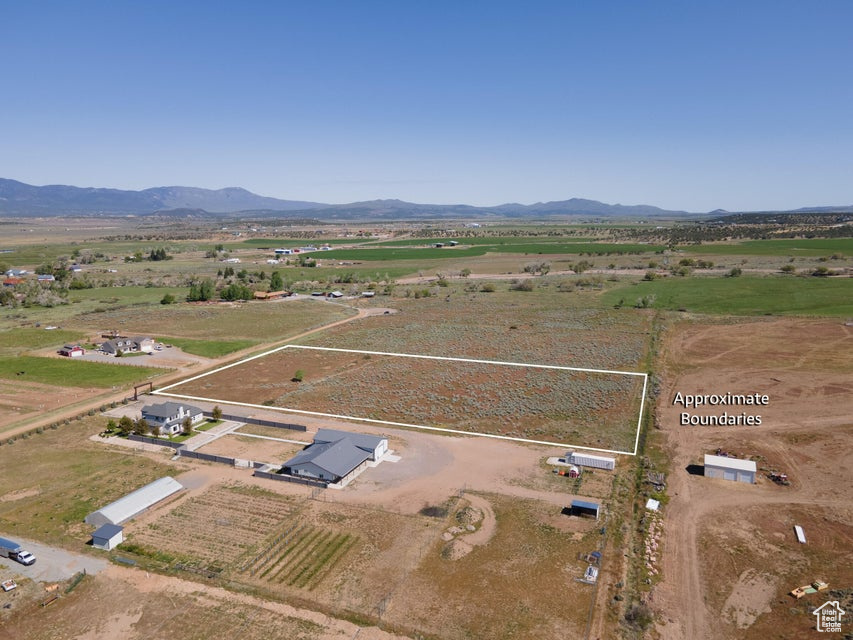 Birds eye view of property with a rural view and a mountain view