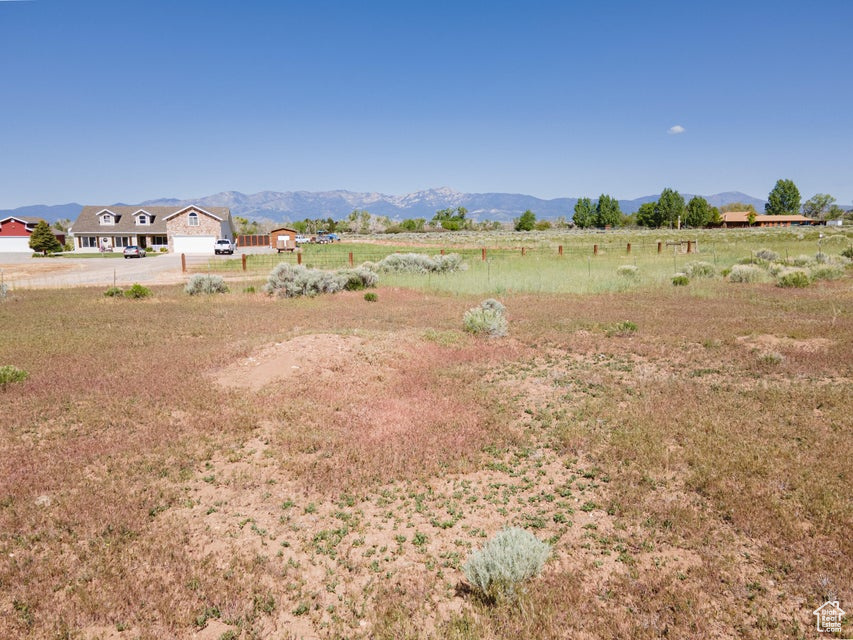 View of yard featuring a rural view and a mountain view