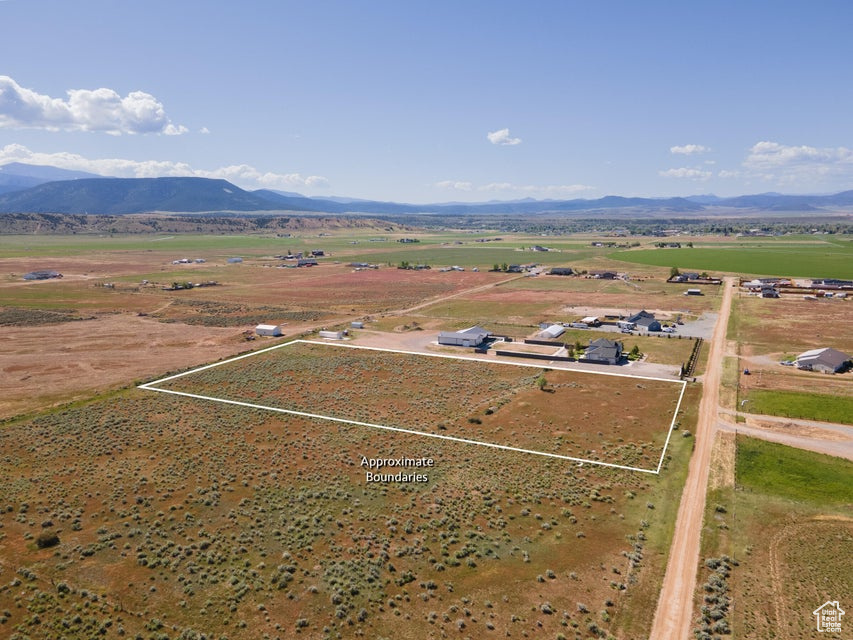 Birds eye view of property with a rural view and a mountain view