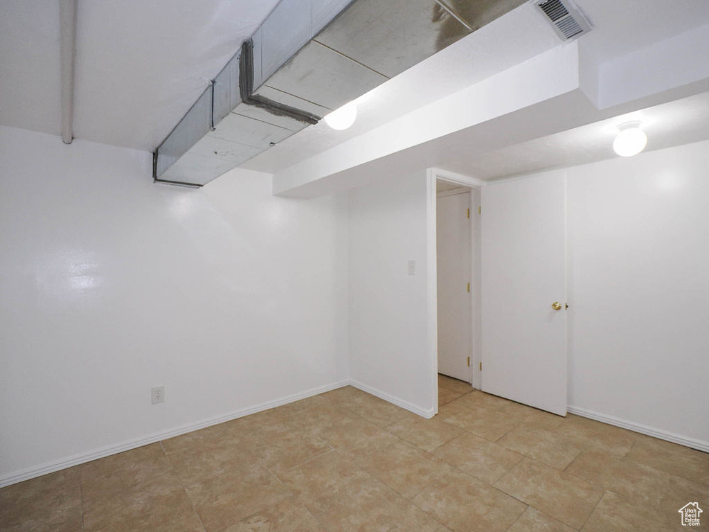 Basement featuring light tile patterned floors