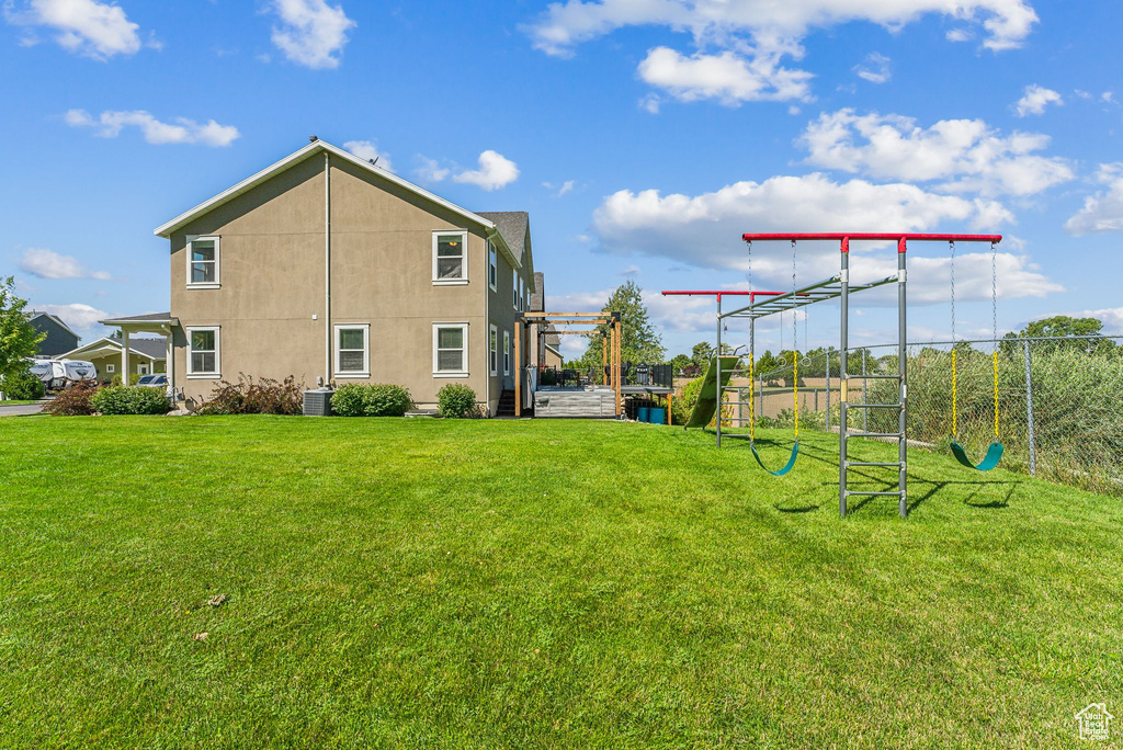 Exterior space featuring central AC and a yard