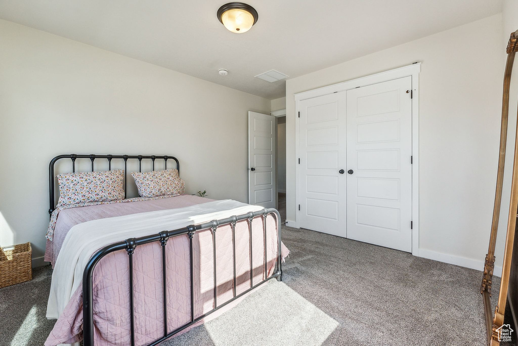 Bedroom featuring a closet and carpet floors