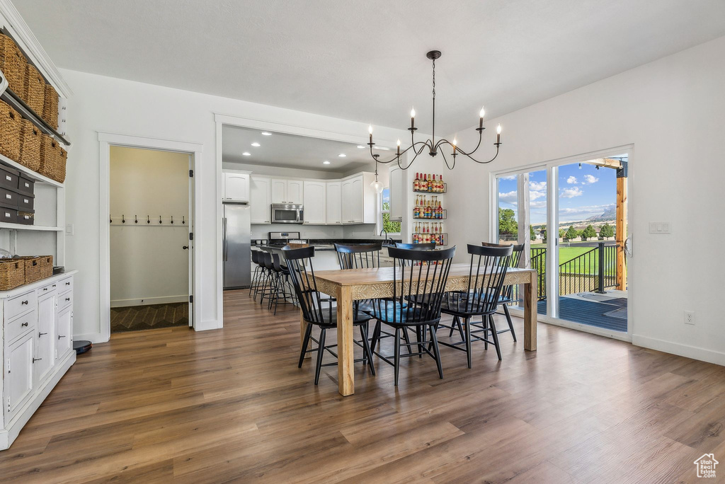 Dining area featuring an inviting chandelier and dark hardwood / wood-style floors