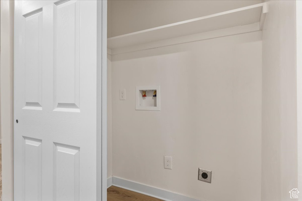 Laundry room featuring hookup for an electric dryer, wood-type flooring, and washer hookup