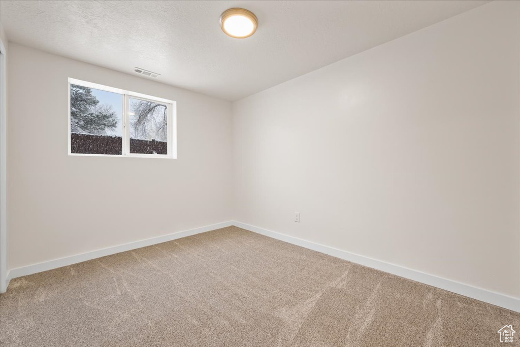 Unfurnished room with carpet floors