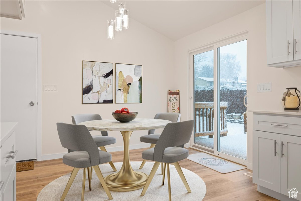 Dining space with light hardwood / wood-style flooring