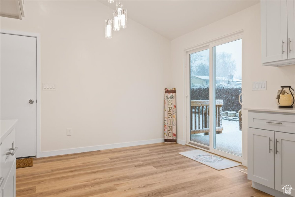 Unfurnished dining area with light wood-type flooring