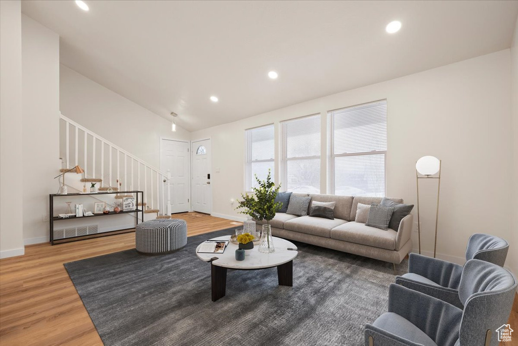 Living room featuring light hardwood / wood-style floors and lofted ceiling