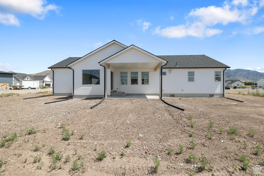 Back of property with a patio