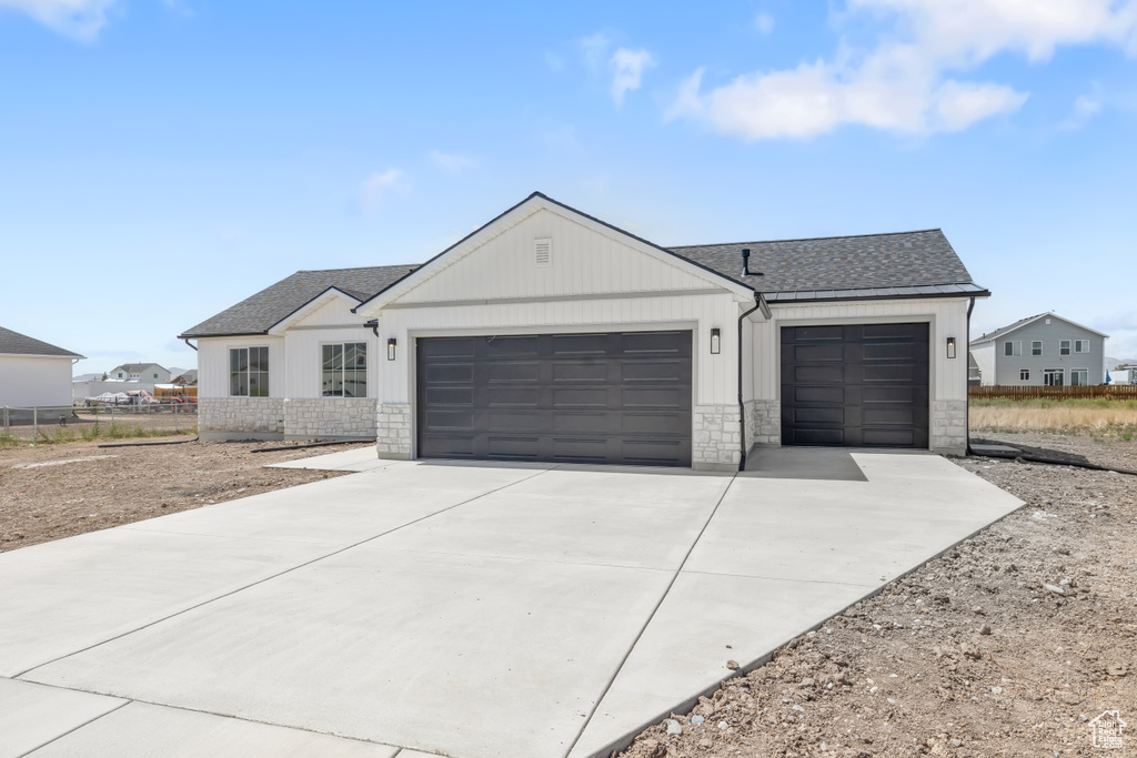 View of front facade featuring a garage