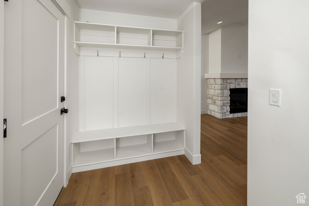 Mudroom with hardwood / wood-style floors and a fireplace