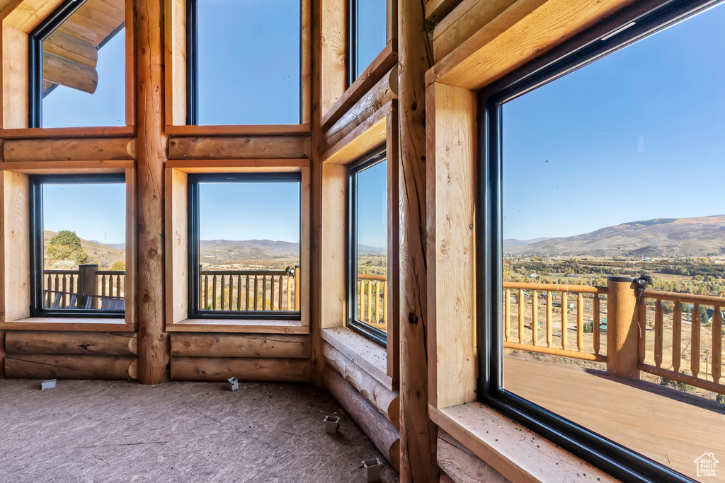 Unfurnished sunroom with a mountain view